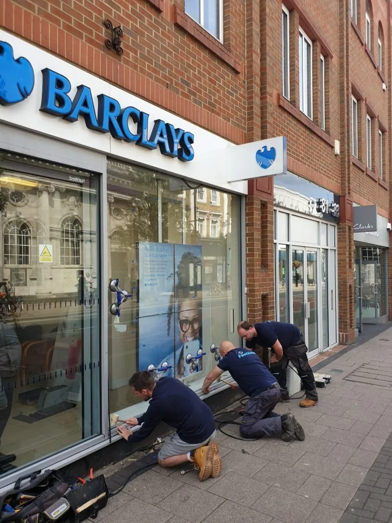 men fixing glass door