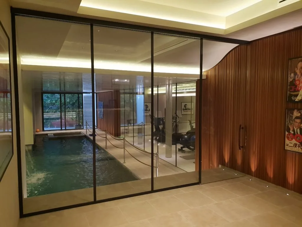 glass door near pool and gym